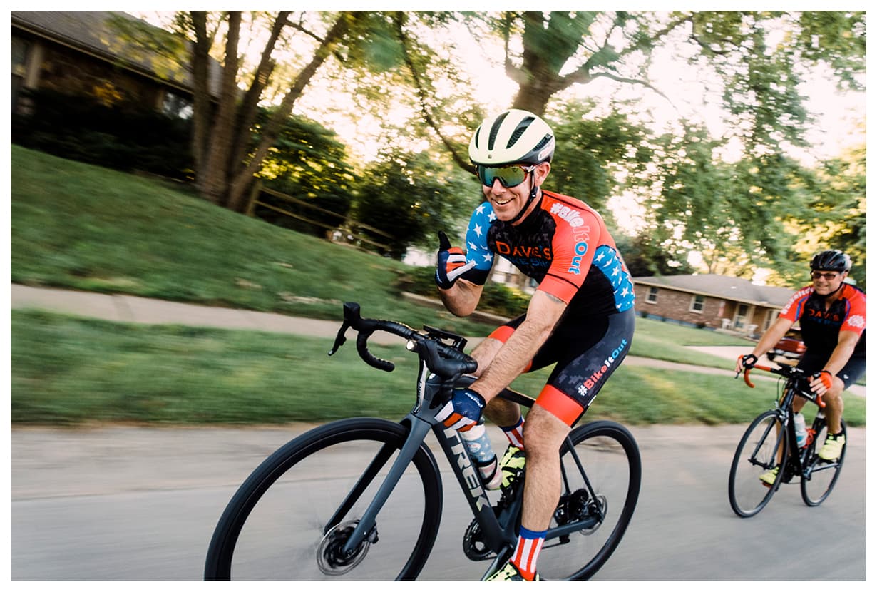 David Forster cycling on a country road at golden hour