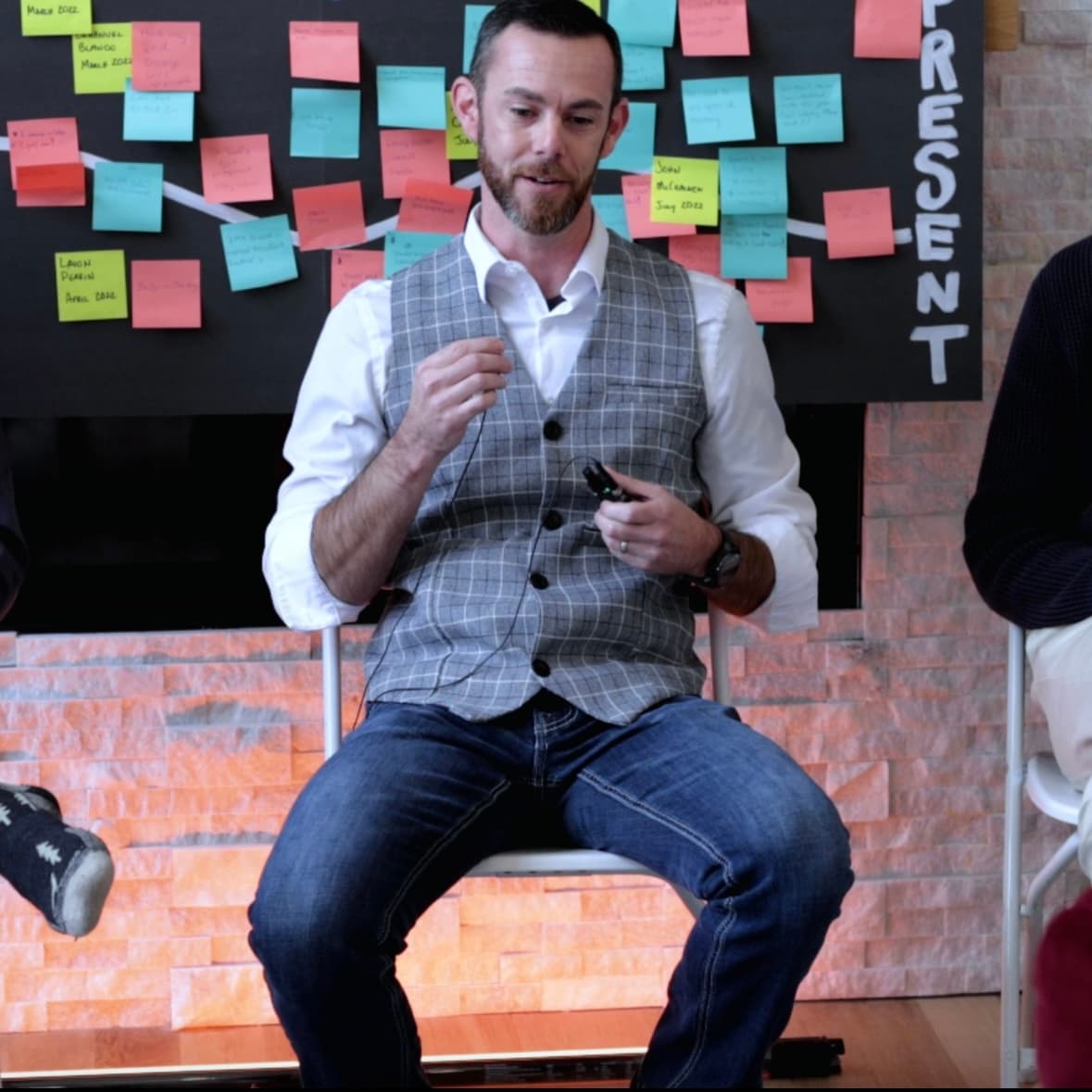 David Forster facilitating a workshop with sticky notes on the wall behind him